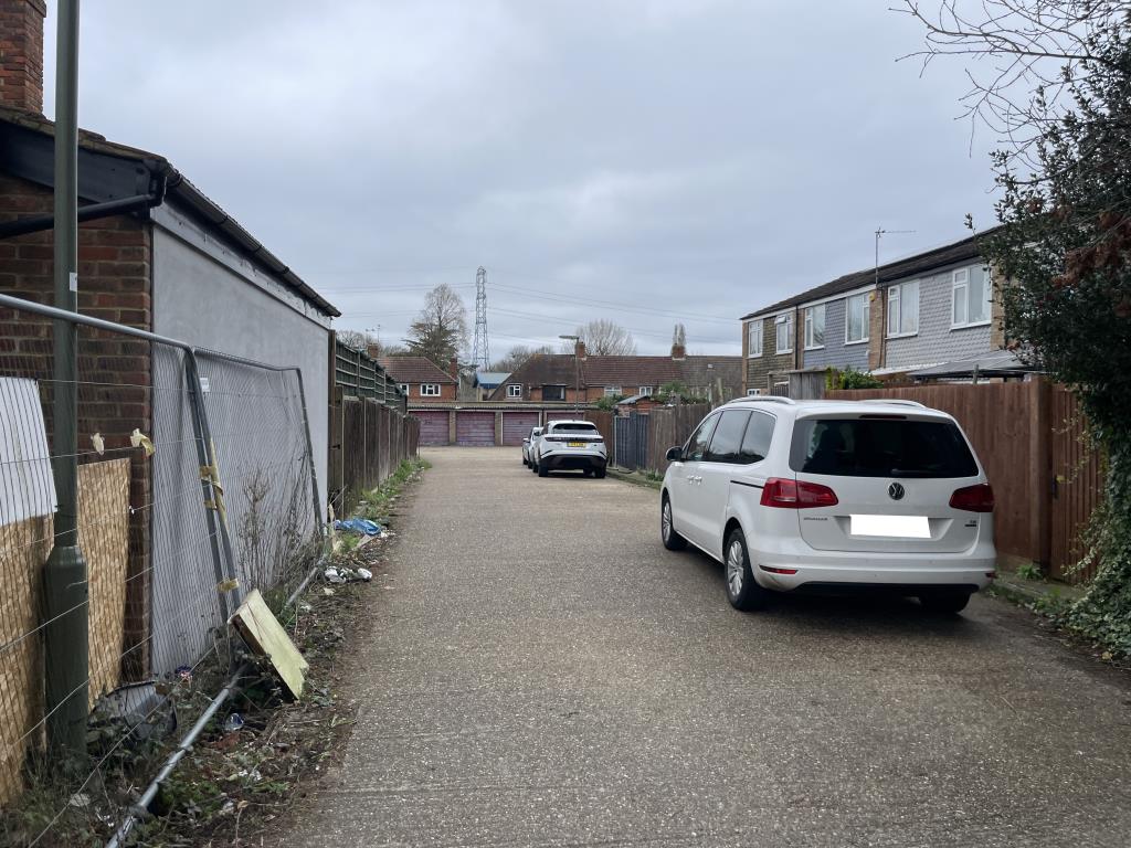 Lot: 111 - LAND AND GARAGES - View of entrance to garage compound of 24 garages